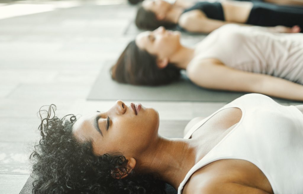 women relaxing in yoga class