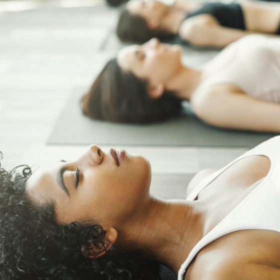women relaxing in yoga class
